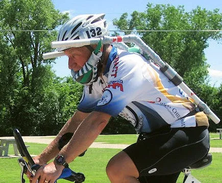 A road cyclist in a race wearing a homemade brace that props up his head