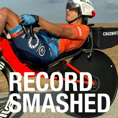 Matthew Lefthand racing a Cruzbike with a disc wheel, under the words Record smashed
