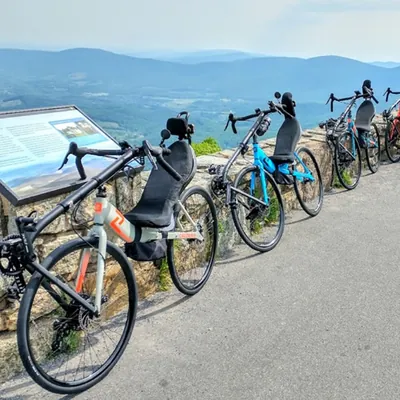 Five Cruzbikes lined up at a mountain overlook